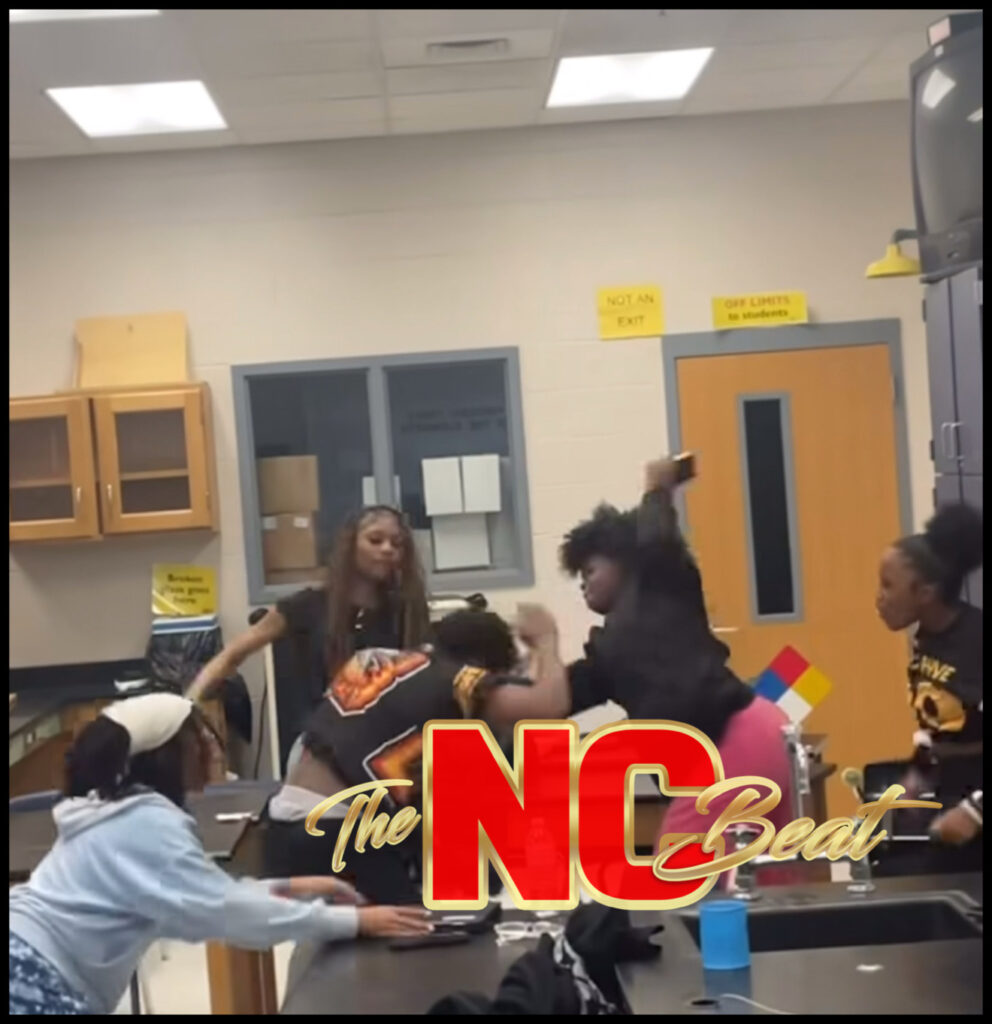 One girl, seen in pink pants, struck a male student with a phone during a group attack at Overhills High School. The video has gone viral.