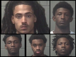 Jacksonville NC gun arrests scene with police lights during firearm seizure at Sandy Run Apartments.