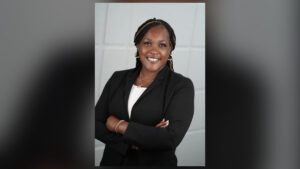 Jamie Stokley, CEO of Helping Hands of the Cape Fear, standing in professional black attire