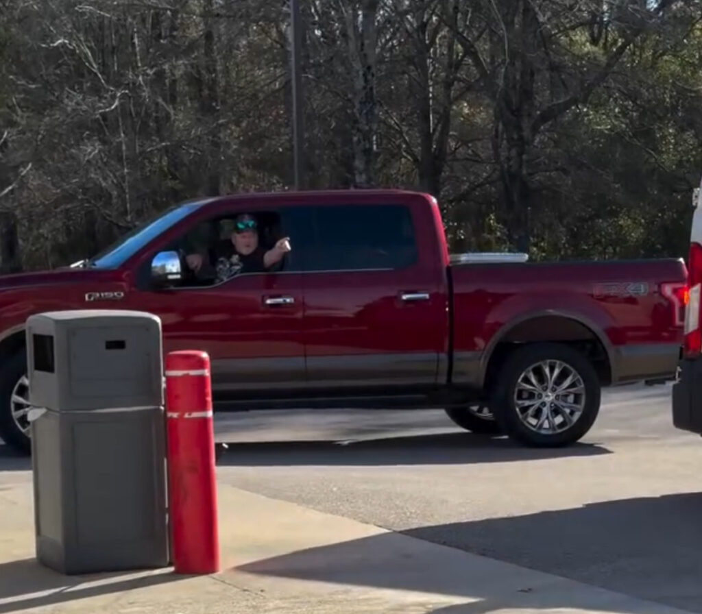 Man pointing out truck window during viral New Bern gas station confrontation