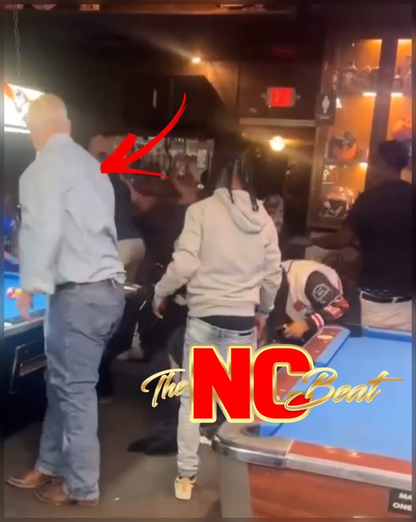 A woman with an Al Sharpton-style hairstyle knocked back during the Crazy D's bar brawl, causing her shirt to fall off.