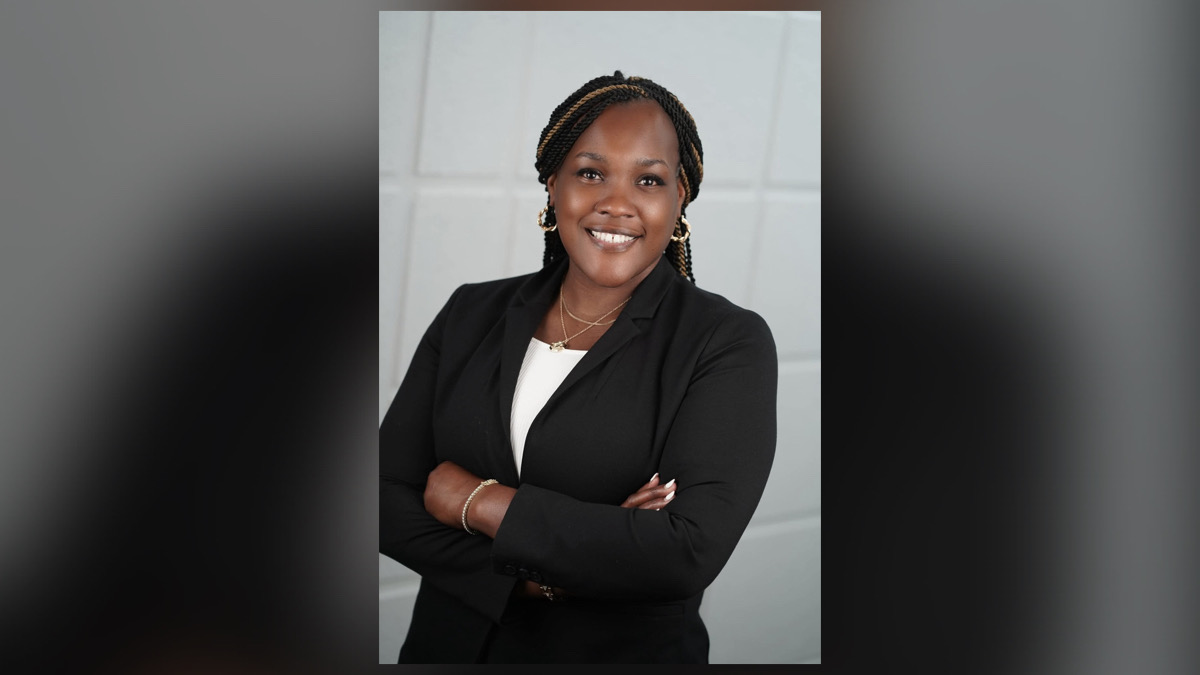 Jamie Stokley, CEO of Helping Hands of the Cape Fear, standing in professional black attire