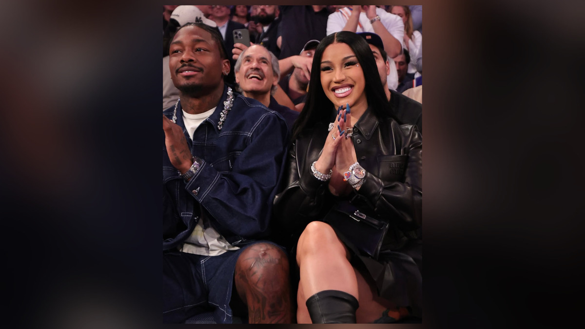 Cardi B and Stefon Diggs celebrating together announcing baby boy pregnancy at public event