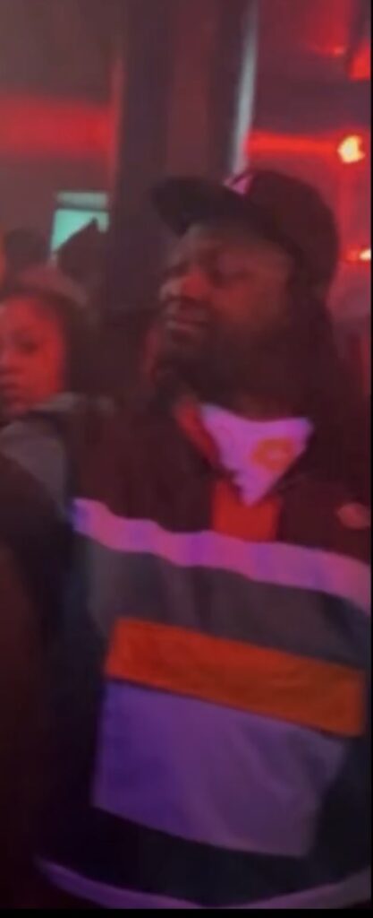 Unidentified man seen flashing a gang hand sign during G-Herbo Fayetteville appearance