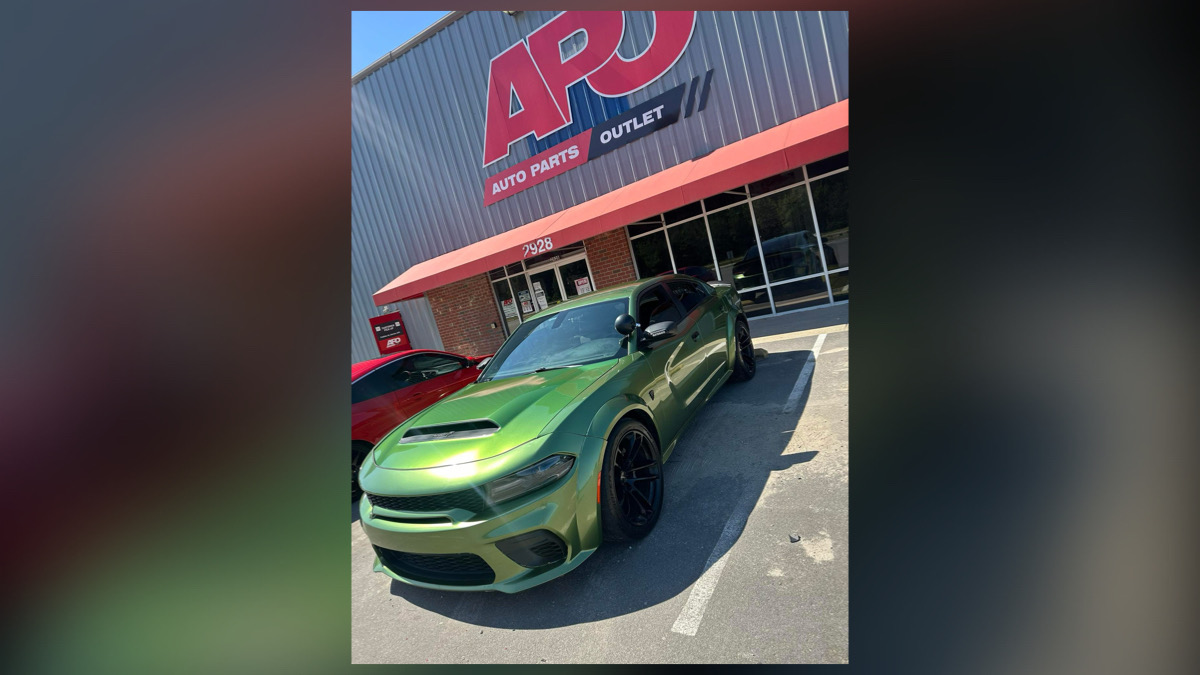 Green Dodge Charger parked in front of APJ auto body shop, Raleigh