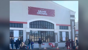 The exterior of a grocery store with a large red 'Grand Opening' banner where MrBeast hosted his 250,000 dollar challenge