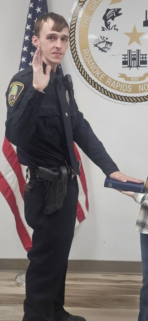 Roanoke Rapids police officer Matthew Simon being sworn in while placing his hand on a Bible