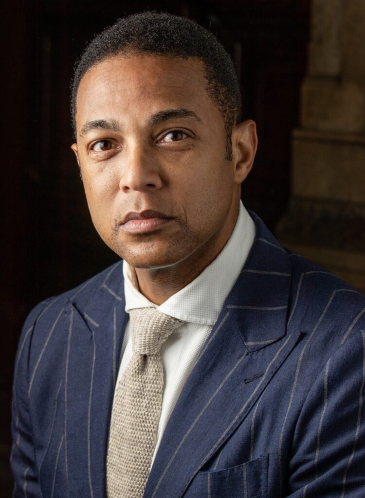 Don Lemon speaking into a yellow microphone during a public event or broadcast
