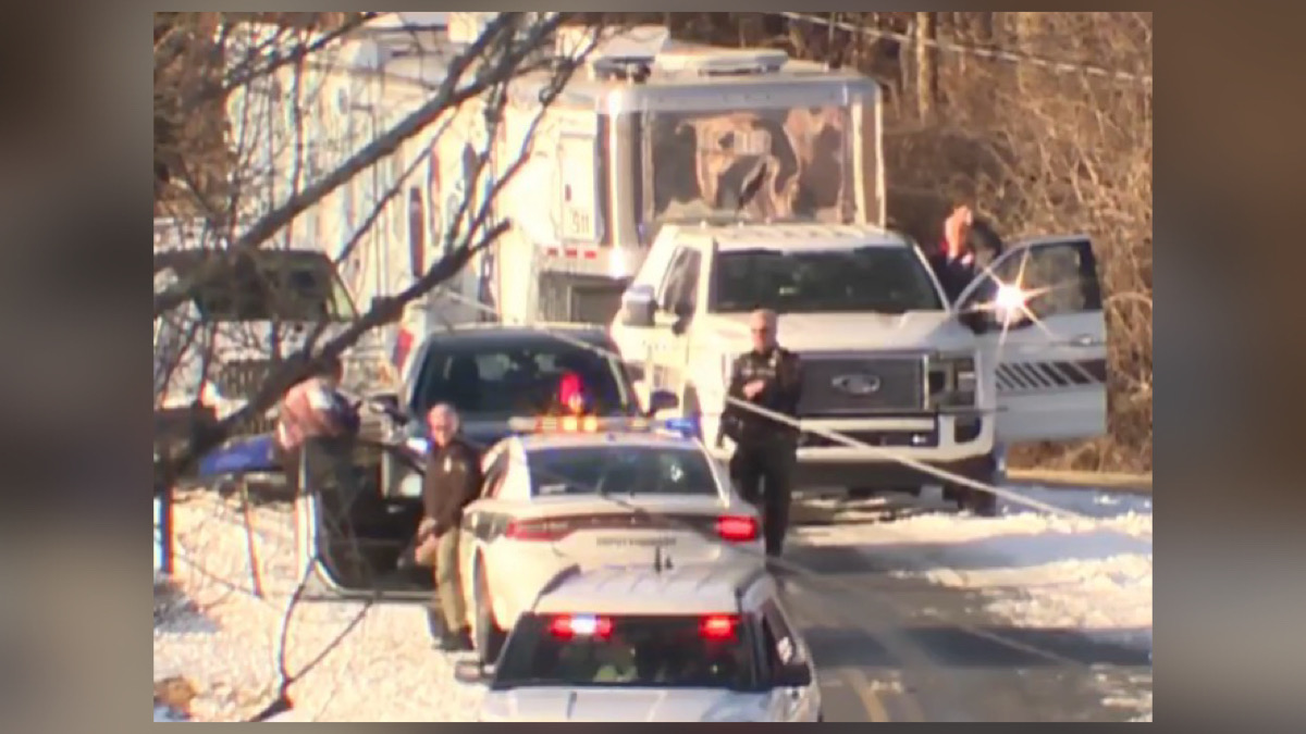 Law enforcement vehicles and emergency responders lined up on a road near Welcome Baptist Church in Mount Airy following a shooting incident