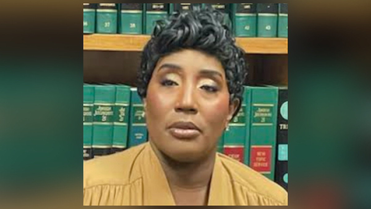 Tiawana Brown, a former Charlotte City Councilwoman, posing in front of a law library bookshelf