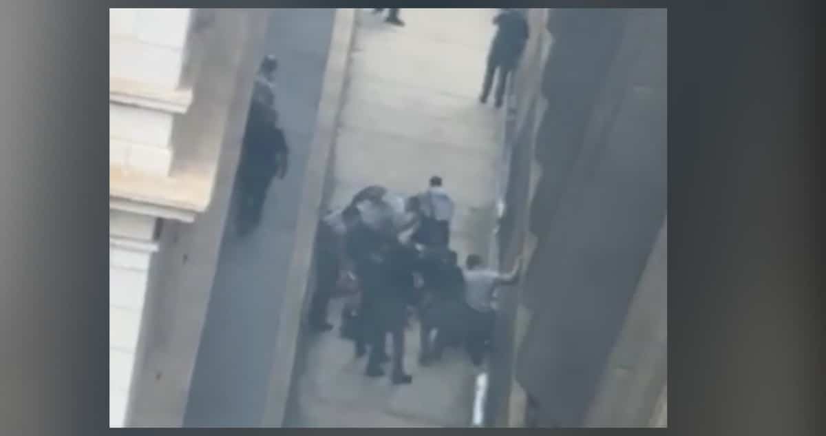 Raleigh police officers secure the scene after two attorneys were shot in a downtown Raleigh shooting on Fayetteville Street near the Wake County Courthouse on May 22, 2026.