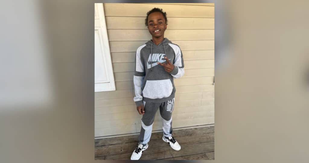 Ladarrius Simmons smiling in grey and white Nike tracksuit