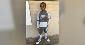 Ladarrius Simmons smiling in grey and white Nike tracksuit